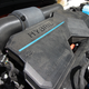 A photo of the hybrid power unit in the front of the Kia Sorento.